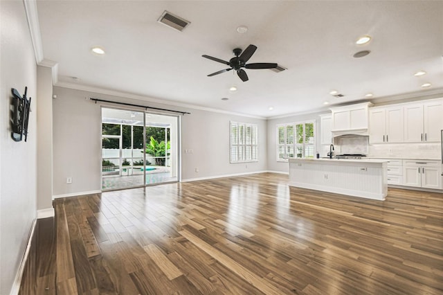 18203 Tivoli Ln, Lutz, FL 33558 - unfurnished living room featuring crown molding, a ceiling fan, wood finished floors, healthy amount of natural light, and recessed lighting