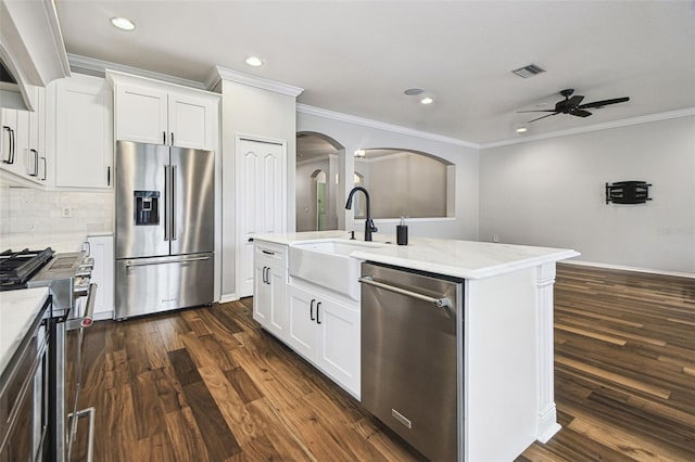 18203 Tivoli Ln, Lutz, FL 33558 - kitchen with appliances with stainless steel finishes, ceiling fan, ornamental molding, recessed lighting, and dark wood finished floors