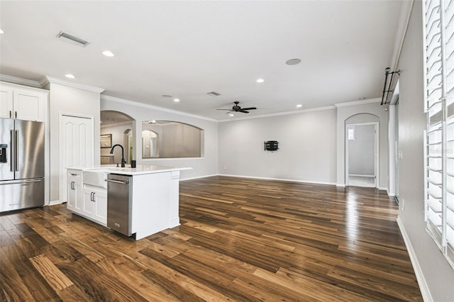 18203 Tivoli Ln, Lutz, FL 33558 - kitchen featuring appliances with stainless steel finishes, arched walkways, ceiling fan, open floor plan, and recessed lighting