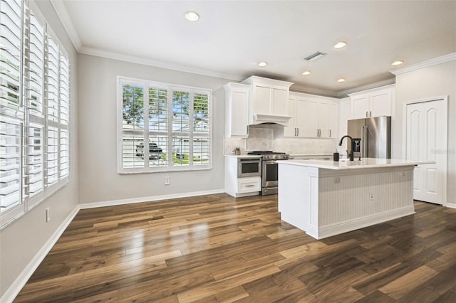 18203 Tivoli Ln, Lutz, FL 33558 - kitchen featuring stainless steel appliances, crown molding, dark wood finished floors, backsplash, and light countertops
