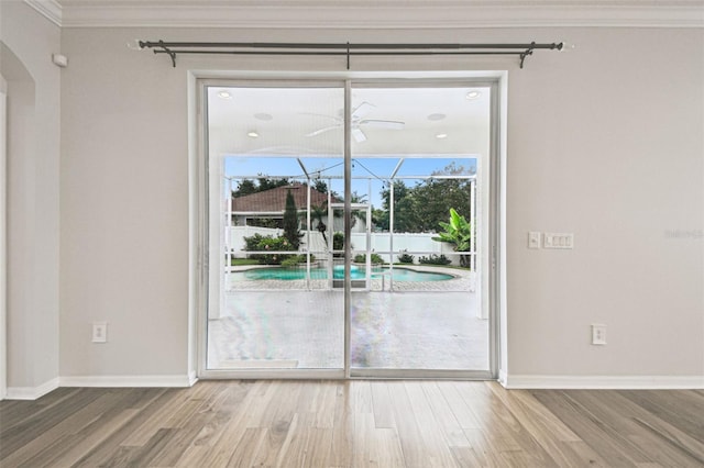 18203 Tivoli Ln, Lutz, FL 33558 - spare room featuring crown molding, wood finished floors, and arched walkways