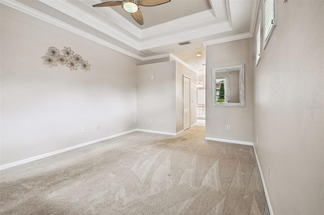 18203 Tivoli Ln, Lutz, FL 33558 - empty room with light carpet, a tray ceiling, ceiling fan, and crown molding