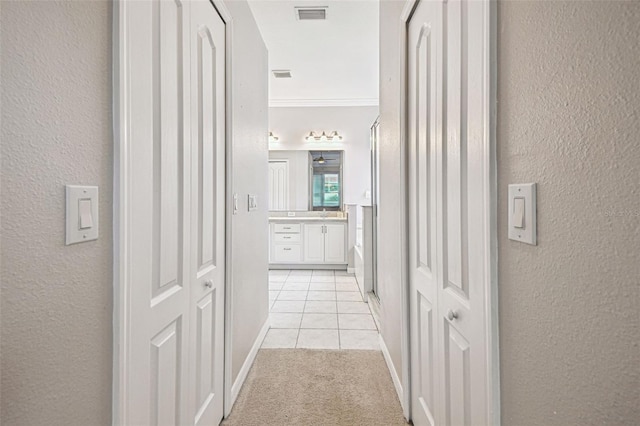18203 Tivoli Ln, Lutz, FL 33558 - corridor with a textured wall, light tile patterned floors, crown molding, and light colored carpet