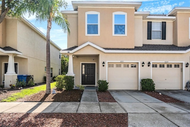 1031 Andrew Aviles Cir, Tampa, FL 33619 - multi unit property featuring an attached garage, stucco siding, and concrete driveway