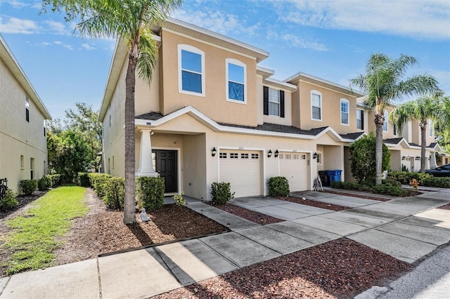 1031 Andrew Aviles Cir, Tampa, FL 33619 - townhome / multi-family property with an attached garage, concrete driveway, and stucco siding