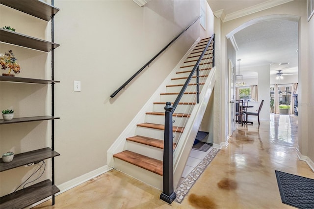 1031 Andrew Aviles Cir, Tampa, FL 33619 - stairway with arched walkways, ornamental molding, a ceiling fan, and concrete floors