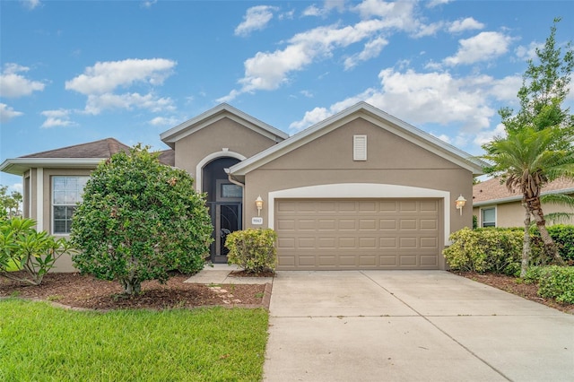 9067 39th Street Cir E, Parrish, FL 34219 - view of front facade featuring stucco siding, concrete driveway, and an attached garage
