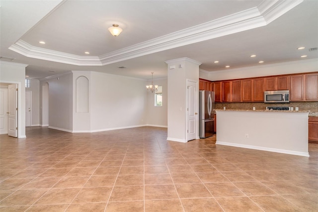 9067 39th Street Cir E, Parrish, FL 34219 - kitchen featuring stainless steel appliances, open floor plan, a chandelier, ornamental molding, and a raised ceiling