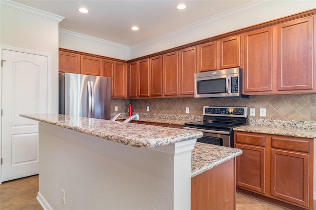 9067 39th Street Cir E, Parrish, FL 34219 - kitchen featuring stainless steel appliances, a kitchen island, brown cabinets, light stone countertops, and decorative backsplash