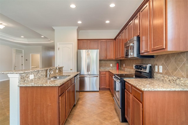 9067 39th Street Cir E, Parrish, FL 34219 - kitchen featuring appliances with stainless steel finishes, crown molding, tasteful backsplash, recessed lighting, and a kitchen island with sink