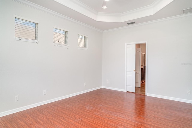9067 39th Street Cir E, Parrish, FL 34219 - empty room featuring a raised ceiling, wood finished floors, and crown molding