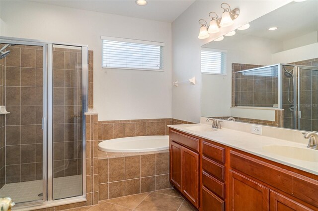 9067 39th Street Cir E, Parrish, FL 34219 - bathroom with a stall shower, a bath, double vanity, tile patterned floors, and recessed lighting