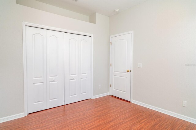 9067 39th Street Cir E, Parrish, FL 34219 - unfurnished bedroom featuring wood finished floors and a closet