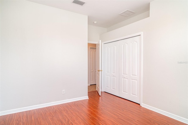 9067 39th Street Cir E, Parrish, FL 34219 - unfurnished bedroom with wood finished floors and a closet