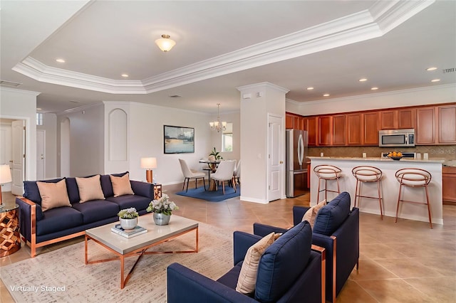 9067 39th Street Cir E, Parrish, FL 34219 - living room featuring ornamental molding, a chandelier, a tray ceiling, light tile patterned flooring, and recessed lighting