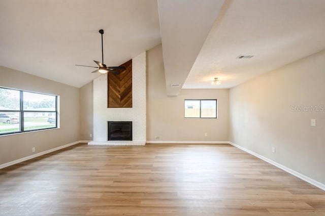 14909 Oldgate Pl, Tampa, FL 33624 - unfurnished living room with ceiling fan, light wood-style flooring, a fireplace, and lofted ceiling