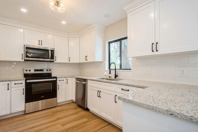 14909 Oldgate Pl, Tampa, FL 33624 - kitchen with stainless steel appliances, white cabinetry, backsplash, and recessed lighting