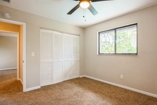 14909 Oldgate Pl, Tampa, FL 33624 - unfurnished bedroom featuring carpet, a closet, and ceiling fan