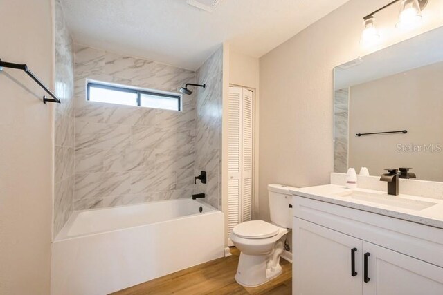 14909 Oldgate Pl, Tampa, FL 33624 - bathroom featuring a closet, vanity, wood finished floors, and shower / tub combination