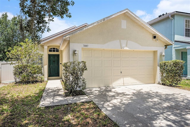 3443 Fyfield Ct, Land O Lakes, FL 34638 - view of front of home featuring stucco siding, a garage, and concrete driveway