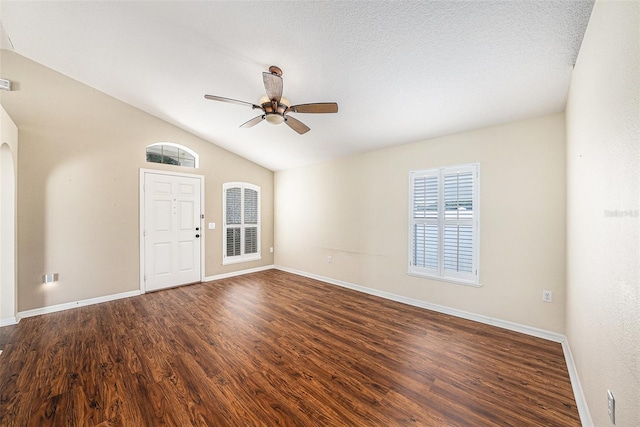 3443 Fyfield Ct, Land O Lakes, FL 34638 - spare room featuring a ceiling fan, vaulted ceiling, wood finished floors, and arched walkways