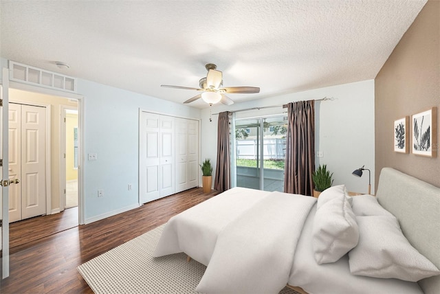 3443 Fyfield Ct, Land O Lakes, FL 34638 - bedroom with dark wood finished floors, access to outside, a ceiling fan, a closet, and a textured ceiling