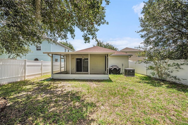 3443 Fyfield Ct, Land O Lakes, FL 34638 - rear view of house with a sunroom, a fenced backyard, and stucco siding