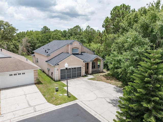8050 Diablo Ct, Trinity, FL 34655 - view of front facade with roof with shingles, concrete driveway, a front yard, a porch, and stucco siding