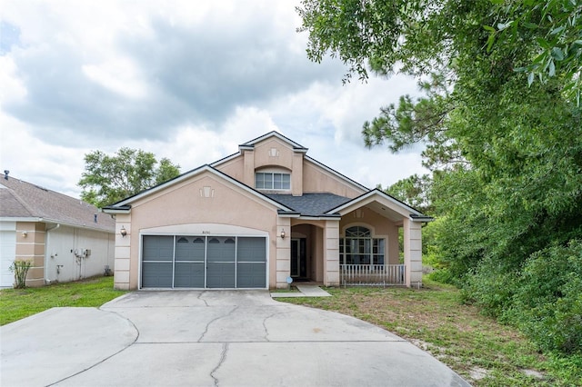 8050 Diablo Ct, Trinity, FL 34655 - view of front facade featuring stucco siding, driveway, an attached garage, and roof with shingles