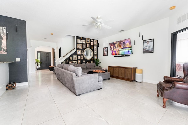 8050 Diablo Ct, Trinity, FL 34655 - living room featuring arched walkways, a ceiling fan, light tile patterned floors, and healthy amount of natural light
