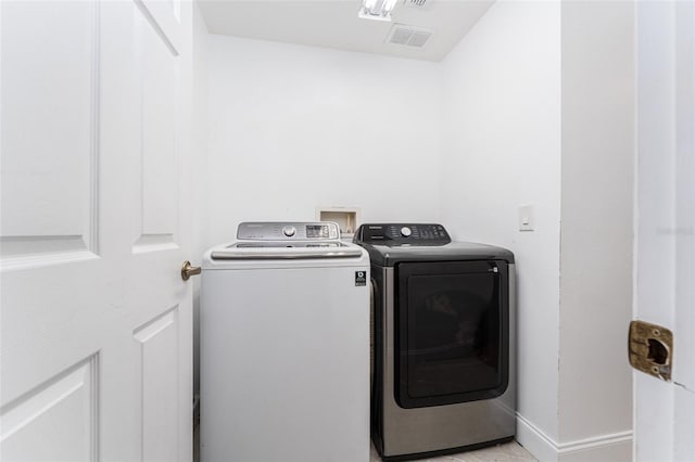 8050 Diablo Ct, Trinity, FL 34655 - laundry room featuring separate washer and dryer and baseboards