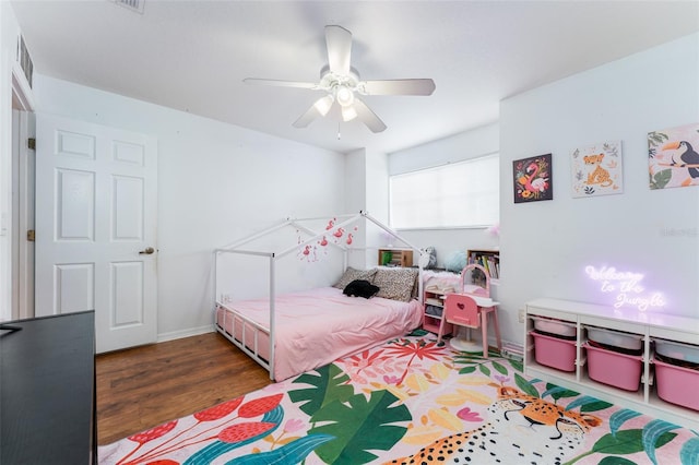 8050 Diablo Ct, Trinity, FL 34655 - bedroom with wood finished floors and a ceiling fan