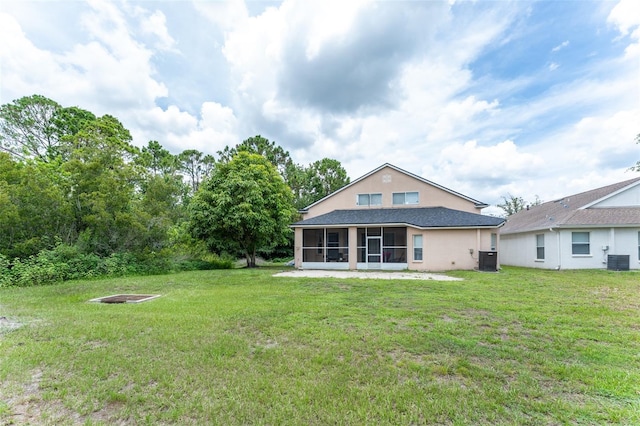 8050 Diablo Ct, Trinity, FL 34655 - rear view of house with a sunroom, a yard, and stucco siding
