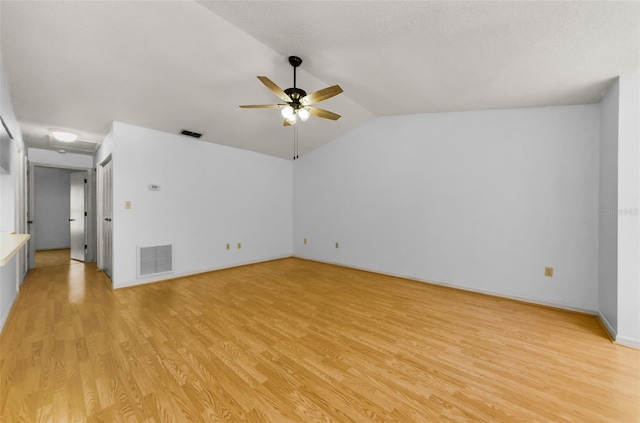 1902 Elaine Dr, Clearwater, FL 33760 - spare room with light wood-type flooring, a ceiling fan, and vaulted ceiling