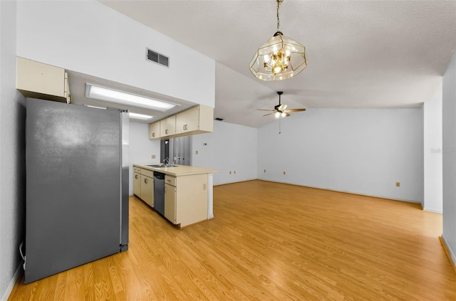 1902 Elaine Dr, Clearwater, FL 33760 - kitchen featuring appliances with stainless steel finishes, ceiling fan, light wood-style floors, light countertops, and a chandelier