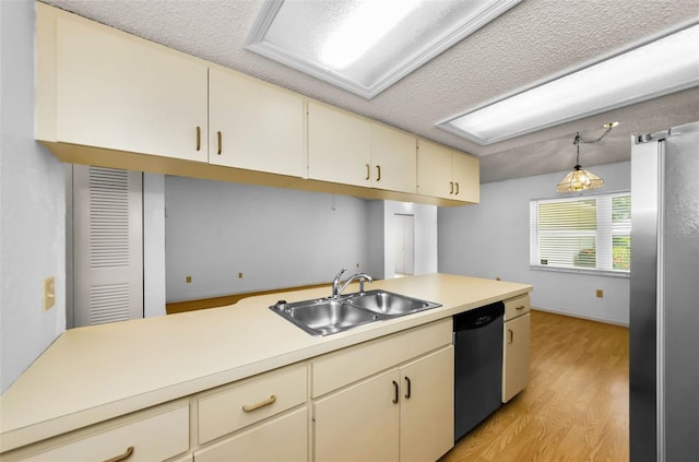 1902 Elaine Dr, Clearwater, FL 33760 - kitchen featuring appliances with stainless steel finishes, cream cabinetry, light countertops, light wood finished floors, and a textured ceiling
