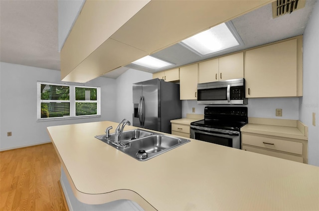 1902 Elaine Dr, Clearwater, FL 33760 - kitchen featuring stainless steel microwave, refrigerator with ice dispenser, electric range, cream cabinetry, and light wood-type flooring