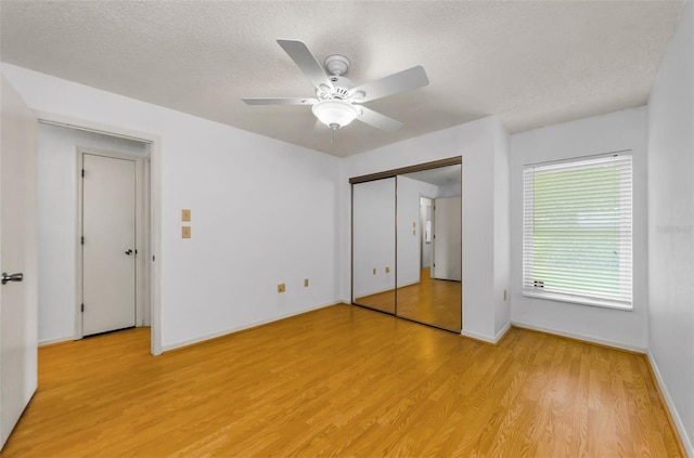 1902 Elaine Dr, Clearwater, FL 33760 - unfurnished bedroom with light wood-style flooring, a textured ceiling, and ceiling fan