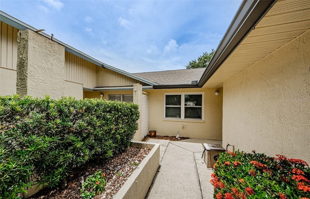 1902 Elaine Dr, Clearwater, FL 33760 - entrance to property featuring stucco siding and a shingled roof