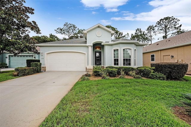 11220 Paradise Pointe Way, New Port Richey, FL 34654 - view of front of house featuring stucco siding, a garage, concrete driveway, and a front yard
