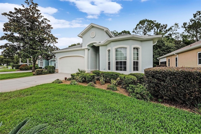 11220 Paradise Pointe Way, New Port Richey, FL 34654 - view of front facade featuring stucco siding, an attached garage, a front lawn, and concrete driveway