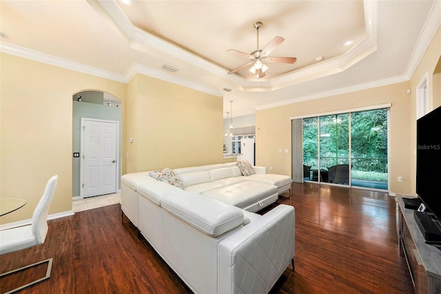 11220 Paradise Pointe Way, New Port Richey, FL 34654 - living room featuring a ceiling fan, a raised ceiling, wood finished floors, arched walkways, and crown molding
