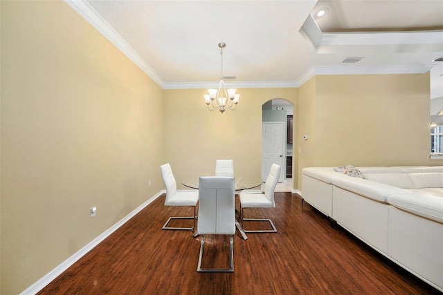 11220 Paradise Pointe Way, New Port Richey, FL 34654 - dining space featuring arched walkways, a chandelier, dark wood finished floors, and crown molding
