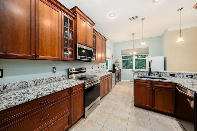 11220 Paradise Pointe Way, New Port Richey, FL 34654 - kitchen with appliances with stainless steel finishes, light stone countertops, decorative light fixtures, light tile patterned floors, and glass insert cabinets