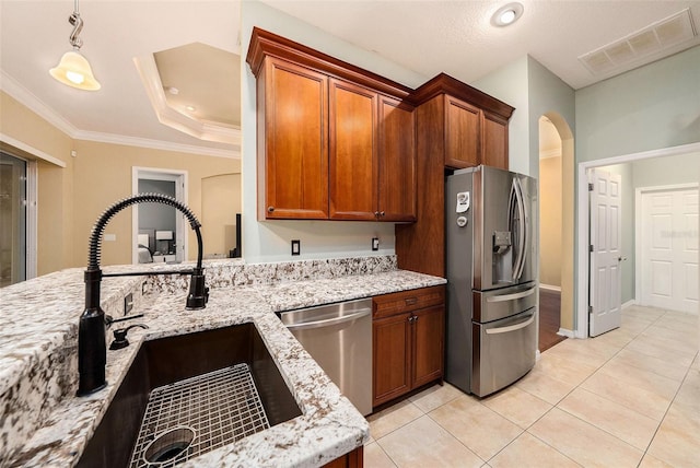 11220 Paradise Pointe Way, New Port Richey, FL 34654 - kitchen with stainless steel appliances, arched walkways, light stone countertops, brown cabinetry, and crown molding