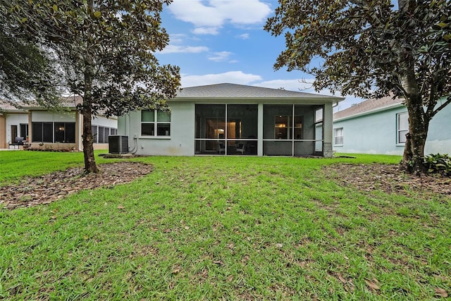 11220 Paradise Pointe Way, New Port Richey, FL 34654 - back of house featuring a lawn and a sunroom