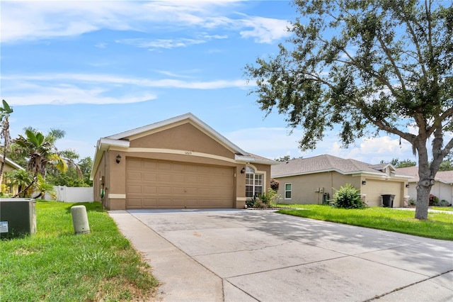 12631 Chenwood Ave, Hudson, FL 34669 - ranch-style house with stucco siding, an attached garage, and concrete driveway