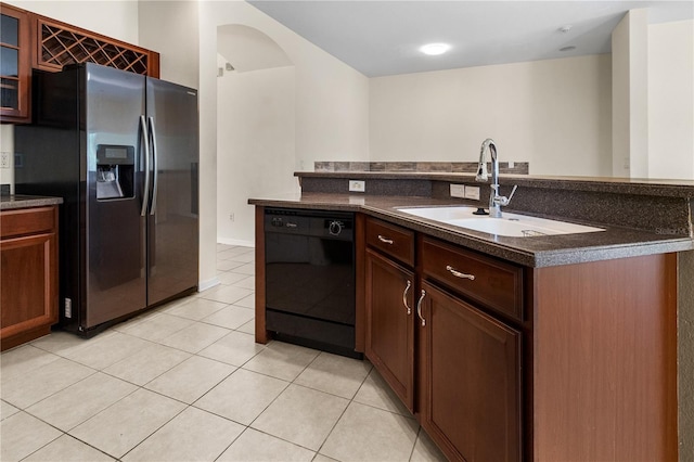 12631 Chenwood Ave, Hudson, FL 34669 - kitchen with dishwasher, refrigerator with ice dispenser, dark countertops, and light tile patterned floors