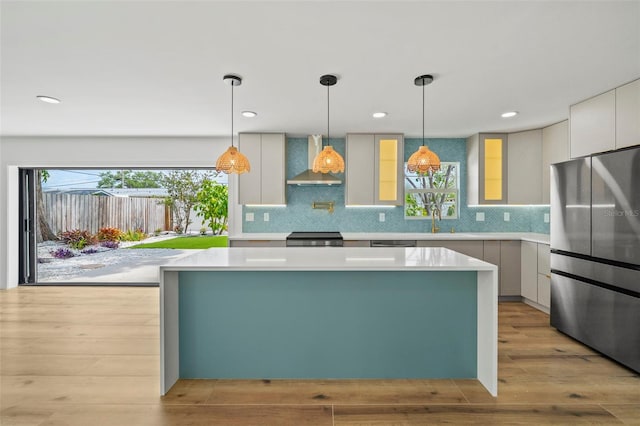 4704 W Fairview Hts, Tampa, FL 33616 - kitchen featuring freestanding refrigerator, wall chimney range hood, modern cabinets, a kitchen island, and recessed lighting