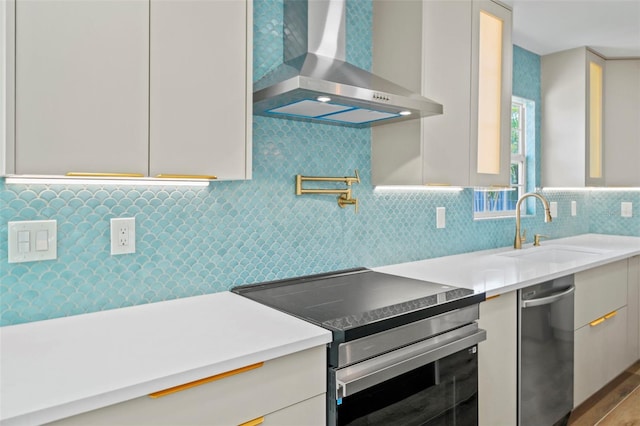 4704 W Fairview Hts, Tampa, FL 33616 - kitchen with wall chimney range hood, electric range, modern cabinets, and light countertops